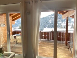 A wooden deck with a view of snow-covered mountains. - Haus Polishet, (Sedrun), 179.06 by Interhome (Sedrun)