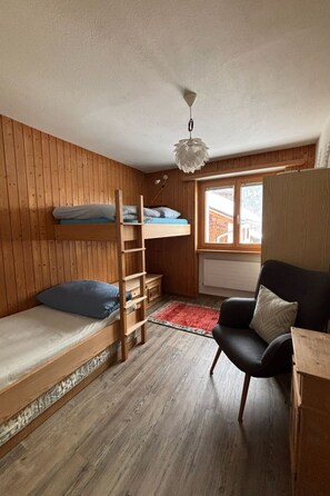 A compact room with a bunk bed, a desk, a chair, and a window. - Tgèsa sil crest Hitz, (Rueras/Sedrun), 677.01 by Interhome (Rueras Dieni)