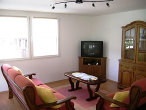 A living room with a sofa set, a television on a stand, and a cabinet. - Casa Aurora Hendry-Canepa, (Sedrun / Cavorgia), 610.01 by Interhome (Sedrun)
