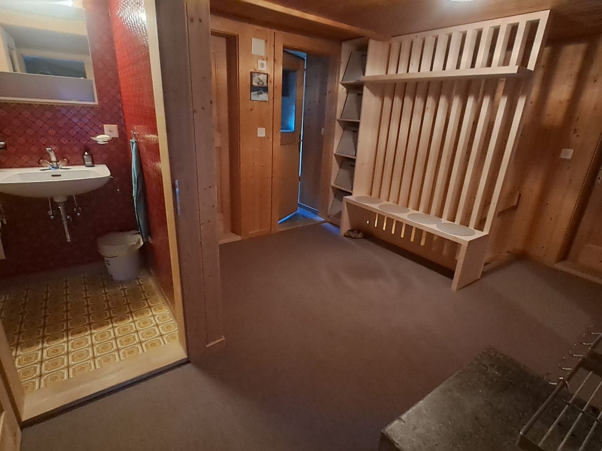 A bathroom with a sink, toilet, and shower area.