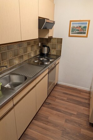 A kitchen with a stainless steel sink, a coffee maker, and a stove. - Disentiserhof Haus C 102, (Disentis/Mustér), 1038 by Interhome (Disentis)
