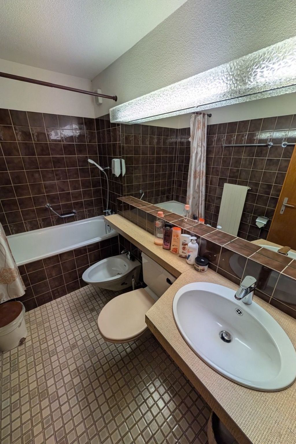 A bathroom with a bathtub, two sinks, a toilet, and a shower.
