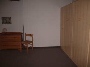 A room with a wooden dresser, a chair, and a wardrobe. - Disentiserhof Garvera, (Disentis/Mustér), 1032 by Interhome (Disentis)