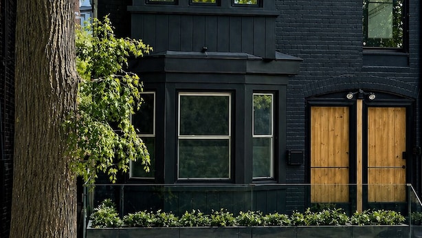 A modern two-story building with large windows, a dark facade, and a stone tree in the foreground. - Full Yorkville House 3Bed w/ Spa, Gym, Parking (Toronto)