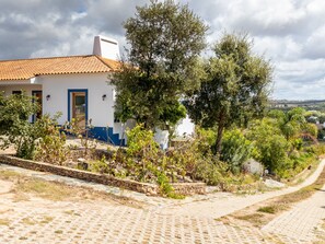 A white building with a tiled roof and a stone pathway leading to it. - MONTE CERRO DA VIGIA by Interhome (São Luís)