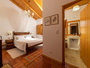 Ein Schlafzimmer mit einem hölzernen Bett, einer Kronleuchter und einem gemusterten Teppich.