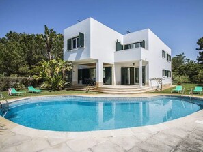 A modern two-story house with a swimming pool, surrounded by greenery and outdoor furniture. - VILLA FATI by Interhome (Tróia)