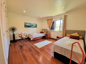 A hotel room with two beds, a fan, a painting, and a window with curtains. - VILLA FATI by Interhome (Tróia)