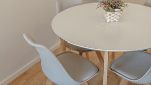 A round table with a checkered tablecloth, surrounded by four grey chairs with wooden legs. - Apartment  by Interhome (Porto)