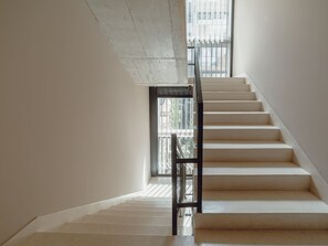 A staircase with a metal handrail leading to a landing. - Apartment  by Interhome (Porto)