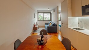 A modern apartment with a dining area, kitchen, and living space. - Apartment  by Interhome (Porto)