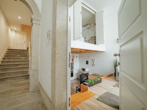 A modern interior with a staircase, a kitchen area, and a dining space. - HISTORIC & BRIGHT BOLHAO MEZZANINE by VACATIONY by Interhome (Porto)