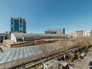 A modern building with a large glass facade and a flat roof with solar panels. - Apartment  by Interhome (Porto)