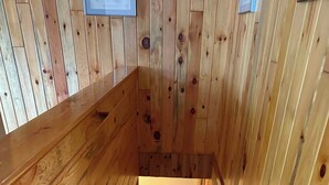 A wooden staircase leading to an upper floor with a view of the sky. - Hayward Riverside Rental (Hayward)
