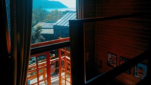 A room with a large window overlooking a mountainous landscape.