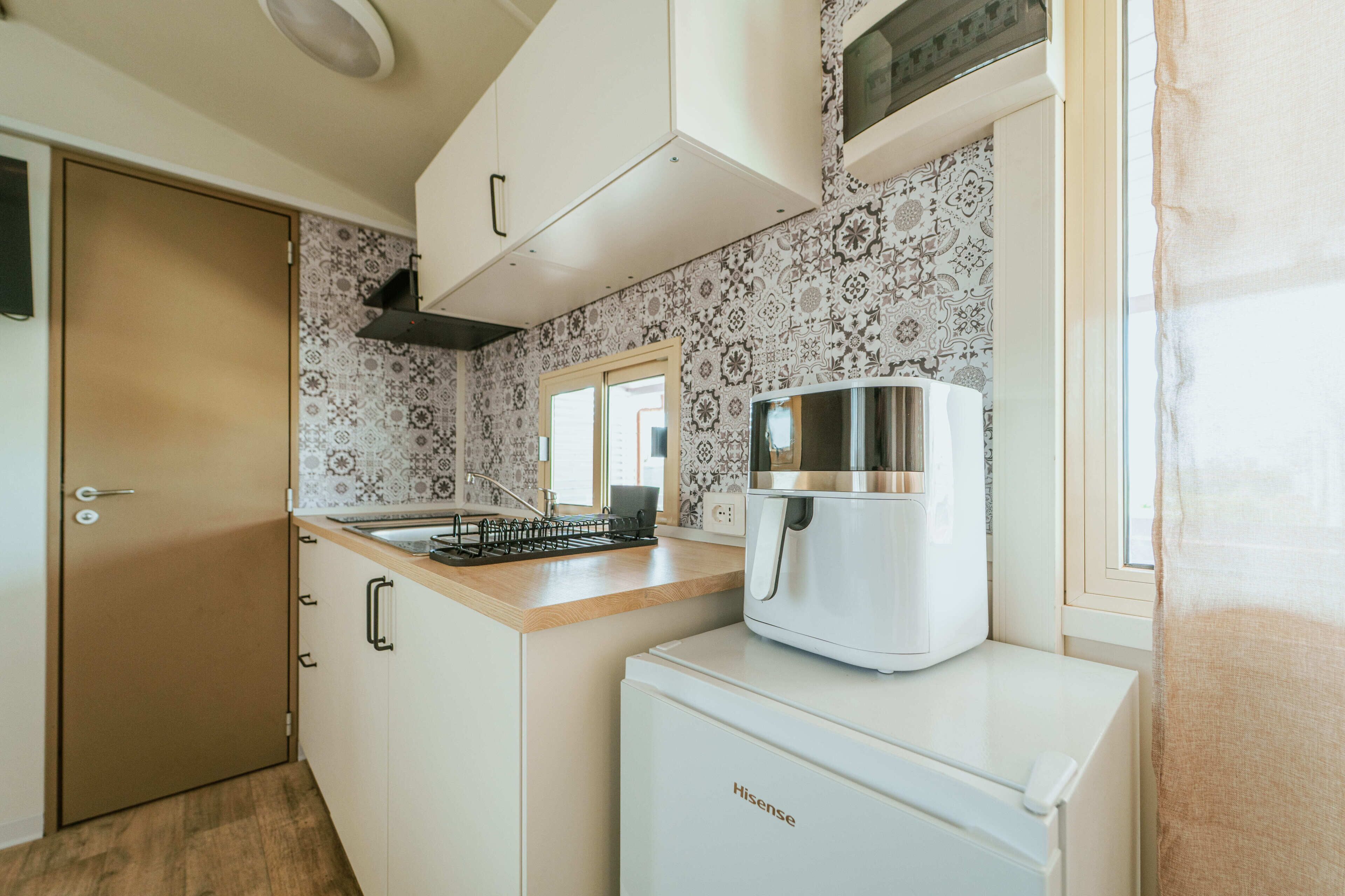 Fridge, stovetop, cookware/dishes/utensils, dining tables