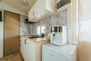 Fridge, stovetop, cookware/dishes/utensils, dining tables