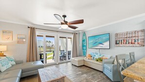 A living room with a ceiling fan, a dining table, a sofa, and a TV. - 2BR Condo Ground Floor Beach Access Pool Sleeps 6 (Panama City Beach)