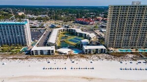An aerial view of a resort with a beach, a pool area, and several high-rise buildings. - 2BR Condo Ground Floor Beach Access Pool Sleeps 6 (Panama City Beach)