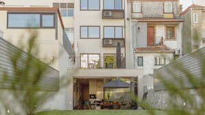 A modern residential building with a flat roof, multiple windows, and a visible balcony. - LEGACY OPORTO PREMIUM APARTMENT B by VACATIONY by Interhome (Porto)