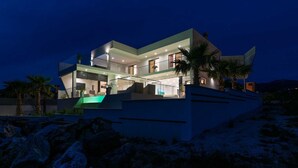 A modern multi-story house with a flat roof, large windows, and a swimming pool. - Vacation home  by Interhome (Rovanjska)