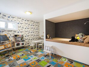 A child's playroom with a bed, toys, and educational toys. - Luxury Villa Michele with infinity pool by Interhome (Rovanjska)