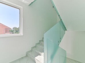 A staircase with glass railings and white marble steps. - Apartment  by Interhome (Zadar/Bibinje)