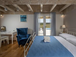 A room with a bed, a desk, a chair, a window with a view, and a painting on the wall. - Charming villa Viliska with heated pool by Interhome (Donje Rastane)