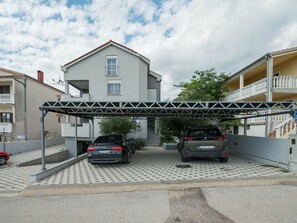 A two-story building with a covered parking area. - Holiday home Viktoria with pool by Interhome (Rovanjska)