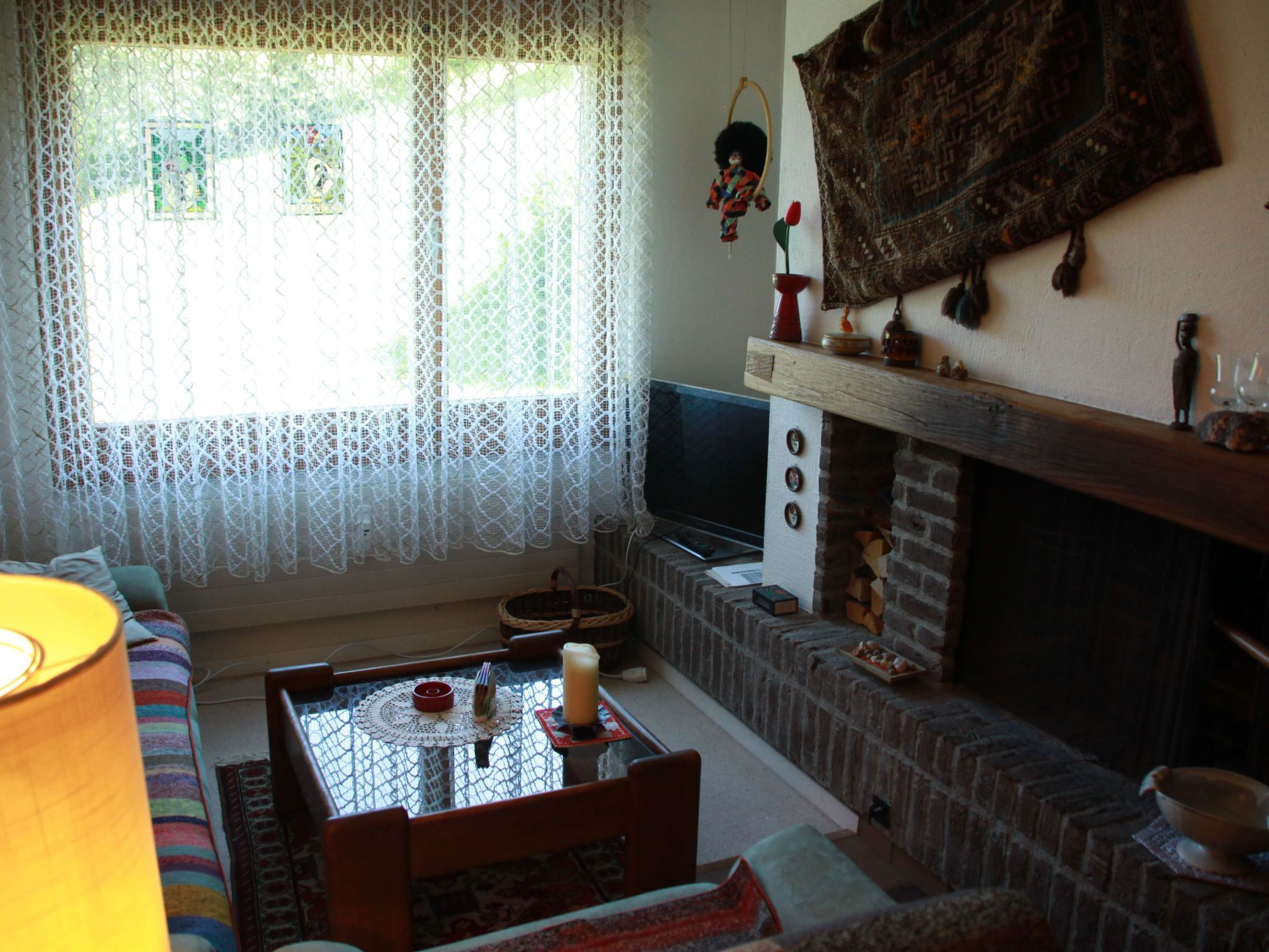 Ein gemütliches Wohnzimmer mit Kamin, Fernseher und einer bequemen Sitzecke.