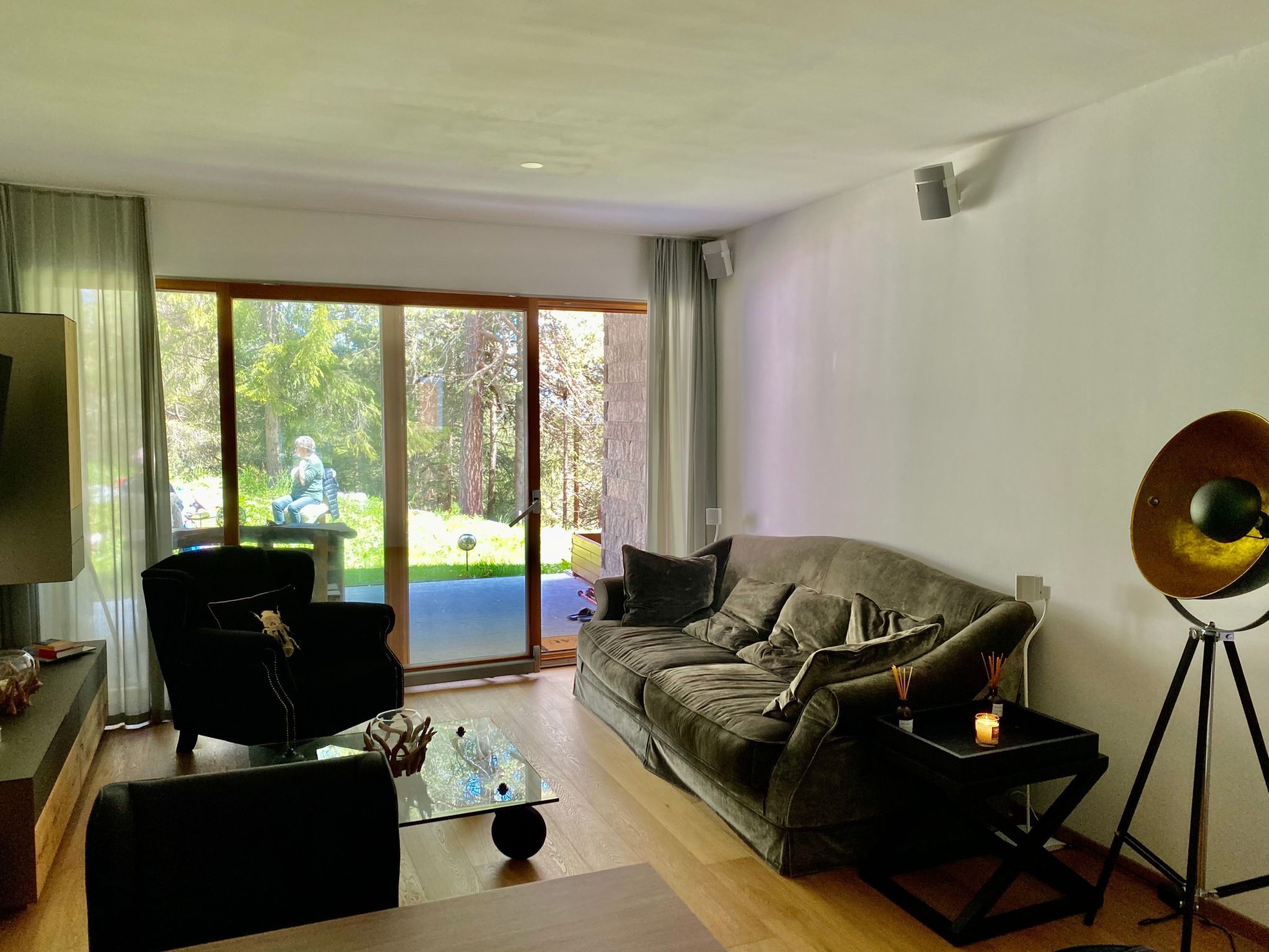 A modern living room with a sofa, a coffee table, and a floor lamp.