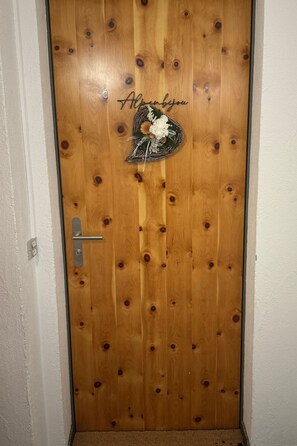 A wooden door with a heart-shaped decoration and the text 'Alpenbayern' on it. - Alpenbijou "CASA BIALA", (Laax GR), by Interhome (Laax)