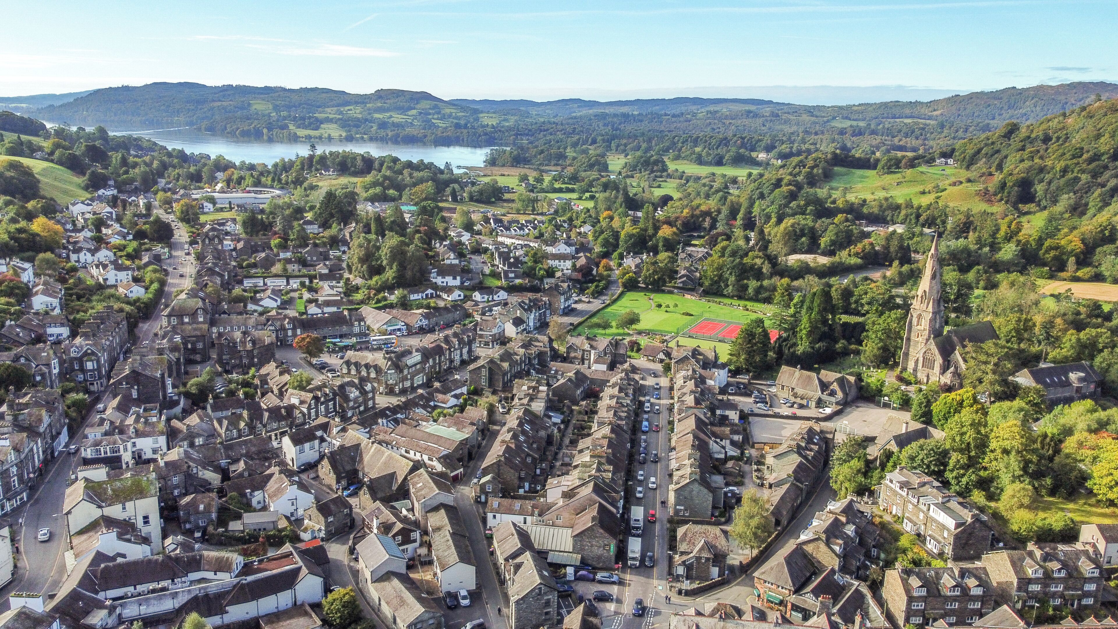 Vista aérea de uma cidade com edifícios históricos, uma igreja e um campo de esportes.