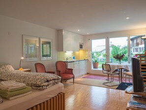 A modern bedroom with a bed, a chair, and a desk with a computer. - Grava, (Laax Dorf), 35045 by Interhome (Laax)