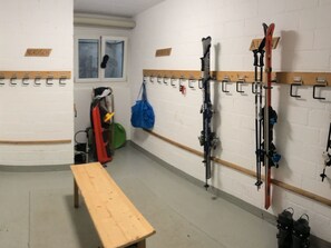 A ski storage room with benches and ski racks. - Casa Primavera B21, (Flims Dorf), by Interhome (Flims)