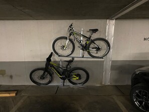 A parking garage with two bicycles mounted on a rack. - Casa Primavera B21, (Flims Dorf), by Interhome (Flims)