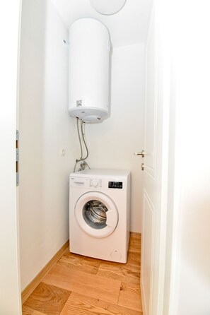 A small laundry room with a washing machine and a water heater. - Vacation home  by Interhome (Crno)