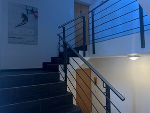 A staircase with a metal railing leading to an upper floor. - Alpatli, Obersaxen-Miraniga, (Obersaxen), 38095B by Interhome (Obersaxen Affeier)
