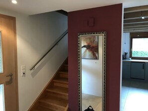 A staircase with a handrail, a framed picture on the wall, and a window with a view of greenery. - Ferienhaus Carrera mit Traumgarten, Valendas, (Valendas), 22007B by Interhome (Valendas)