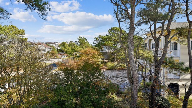 Un quartiere residenziale con case, alberi e cielo sereno.