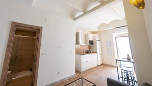 A modern kitchen with white cabinets, a microwave, and a sink. - San Miguel Bajo Apartment (Granada)