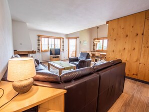 A modern living room with a sofa, a coffee table, and a TV. - La Prada Seipel, Brigels, (Breil/Brigels), 65031B by Interhome (Breil/Brigels)