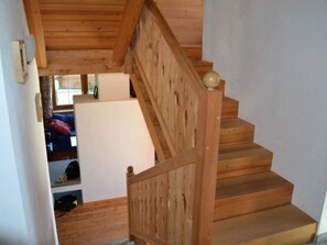 A wooden staircase with a handrail leading to a second-floor landing. - Ferienhaus Casa Patricia, Brigels, (Breil/Brigels), 65046B by Interhome (Breil/Brigels)