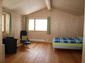 A room with a bed, a chair, and a desk. - Studio Bäch, Safien-Thalkirch, (Thalkirch (Safien)), 09002B by Interhome (Thalkirch)