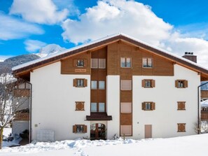 A two-story building with a symmetrical facade, wooden shutters, and a central entrance. - Davos Caplan Ledermann, Vella, (Vella), 44006B by Interhome (Vella)