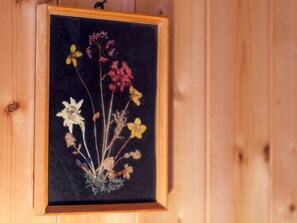 A framed botanical specimen with various flowers and foliage.