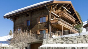 A wooden chalet with a stone foundation, a balcony, and a snow-covered roof. - Genoveva Sax, Obersaxen-Meierhof, (Obersaxen), 34065B by Interhome (Obersaxen Affeier)