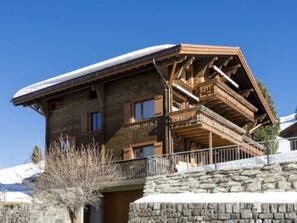 A wooden chalet with a stone foundation, a balcony, and a snow-covered roof. - Genoveva Sax, Obersaxen-Meierhof, (Obersaxen), 34065B by Interhome (Obersaxen Affeier)