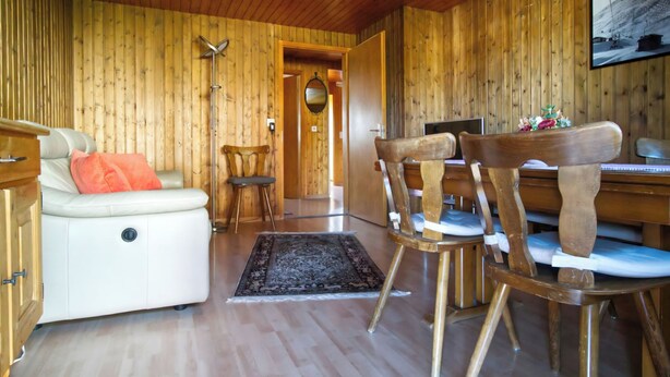 A wooden interior with a sofa, chairs, a desk, and a rug. - Genoveva Sax, Obersaxen-Meierhof, (Obersaxen), 34065B by Interhome (Obersaxen Affeier)