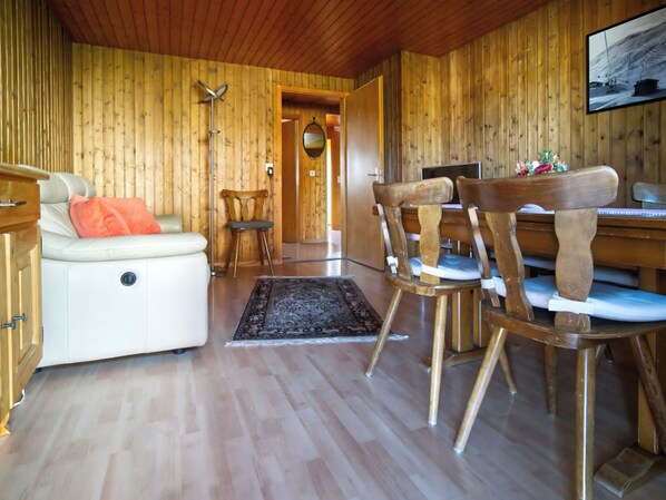A wooden interior with a sofa, chairs, a desk, and a rug. - Genoveva Sax, Obersaxen-Meierhof, (Obersaxen), 34065B by Interhome (Obersaxen Affeier)
